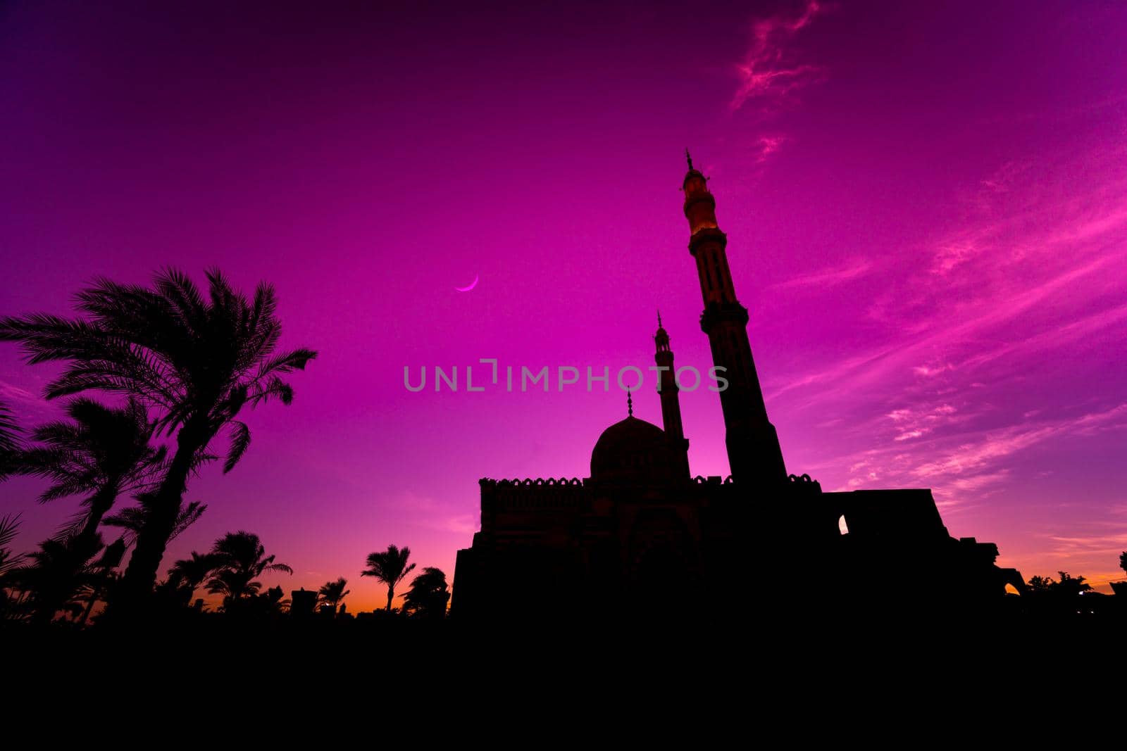 Beautiful large Islamic mosque at the sunset sky background.