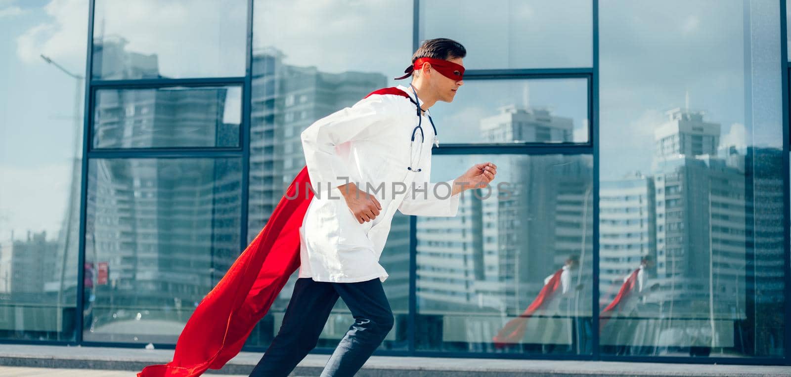 doctor is a superhero running through the city streets. photo with a copy-space.