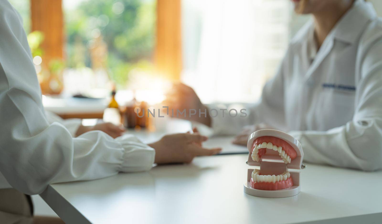dentist and patient discussion about planned teeth treatment in dental clinic office - dentist consultation concept.