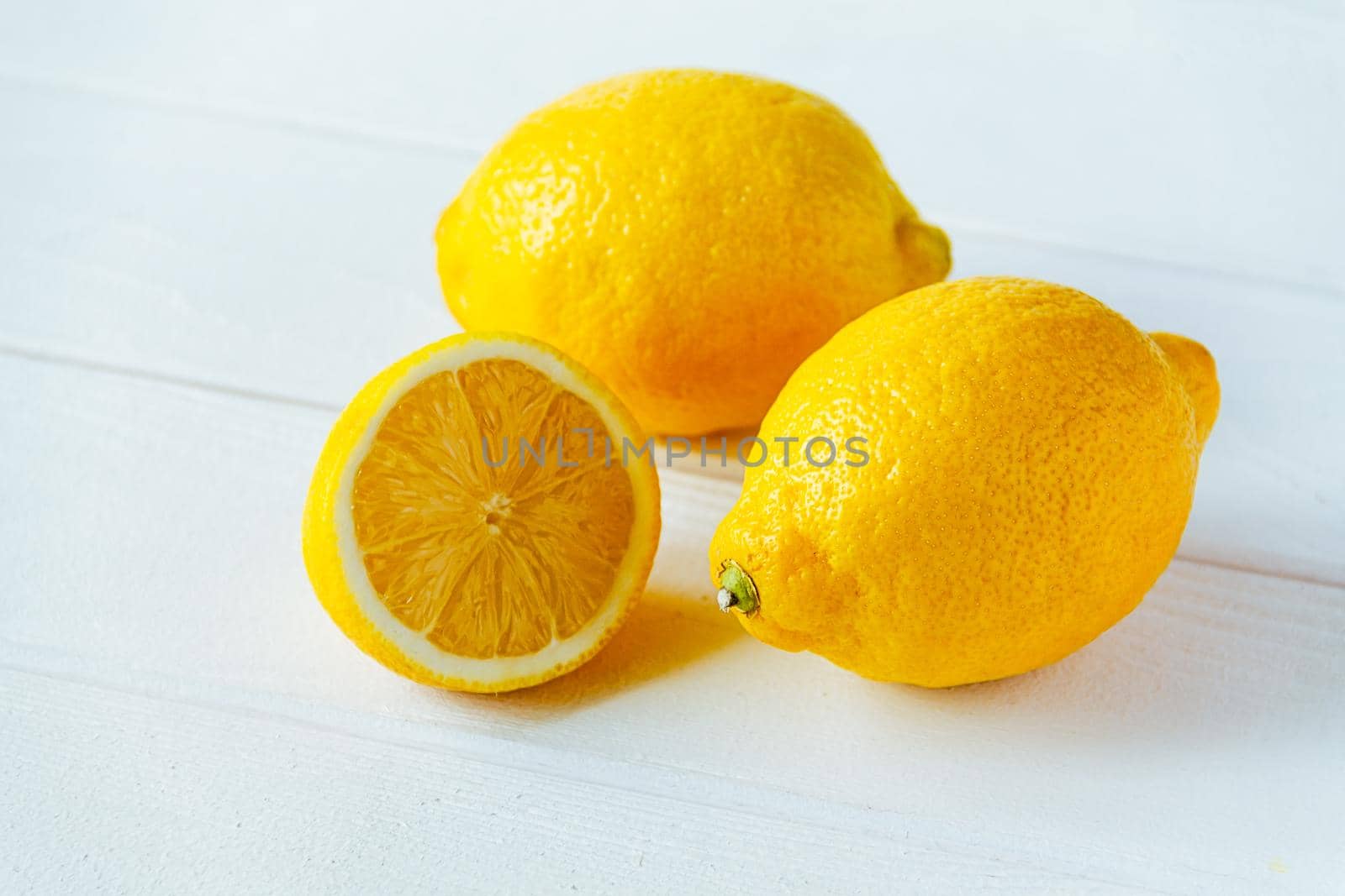 fresh sliced lemon on white wooden natural background