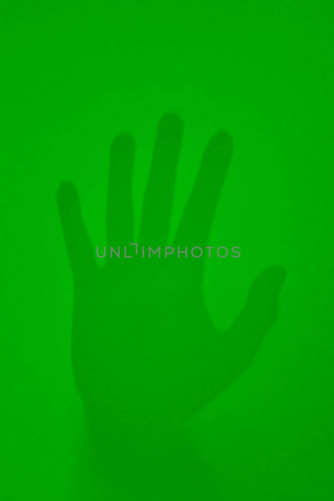 On a green background is the imprint of a man's hand