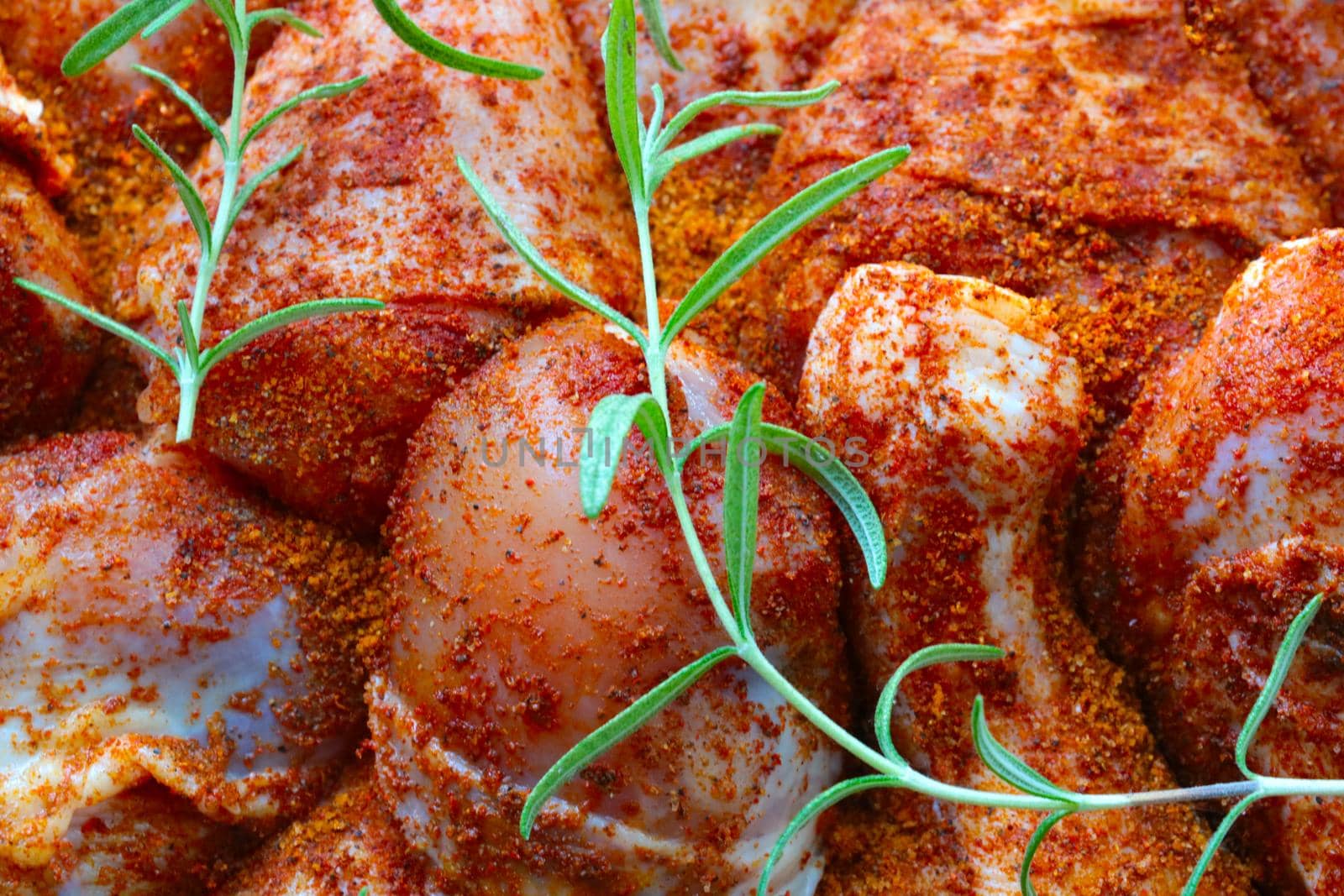 Pieces of chicken in specialties and rosemary branches