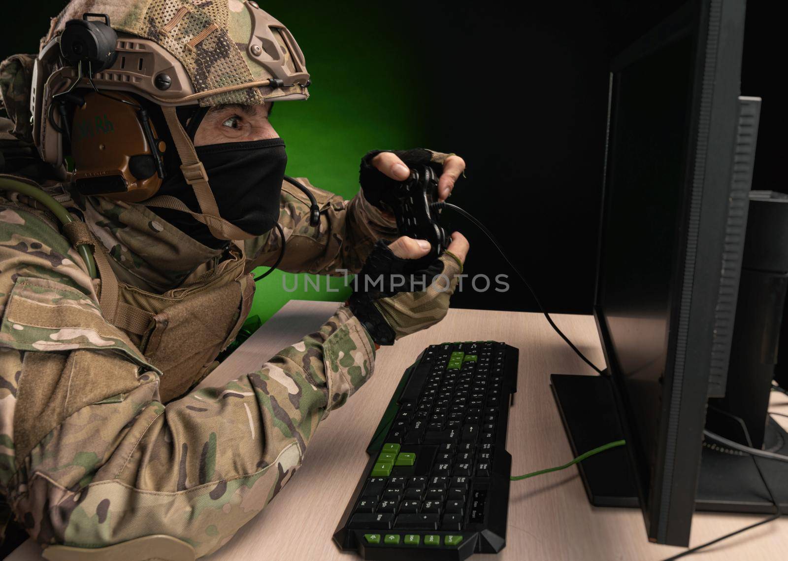 military soldier at a computer is conducting a cyber war
