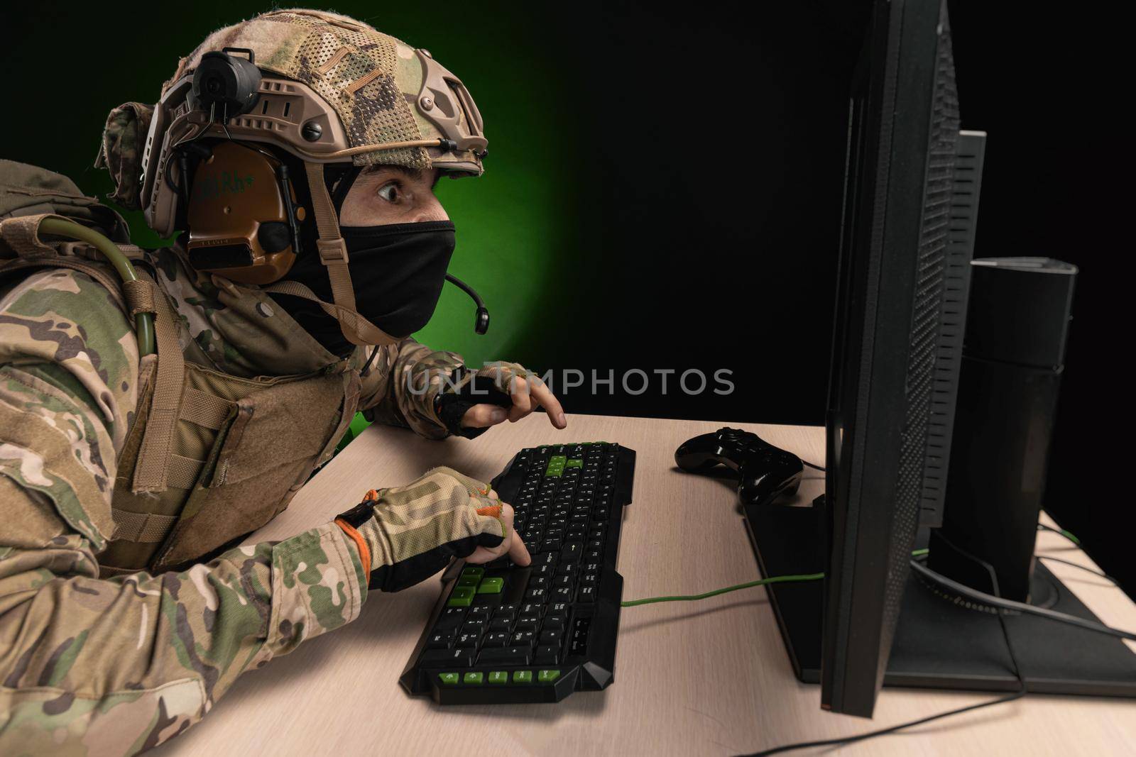 military soldier at a computer is conducting a cyber war