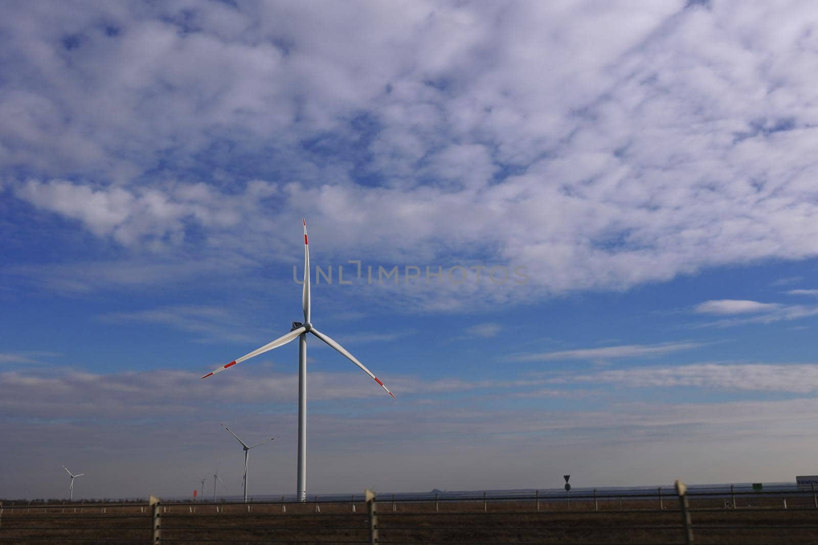 Wind Turbine Producing Clean Power Electric Energy. Green energy concept. Wind Power Renewable Energy Plant