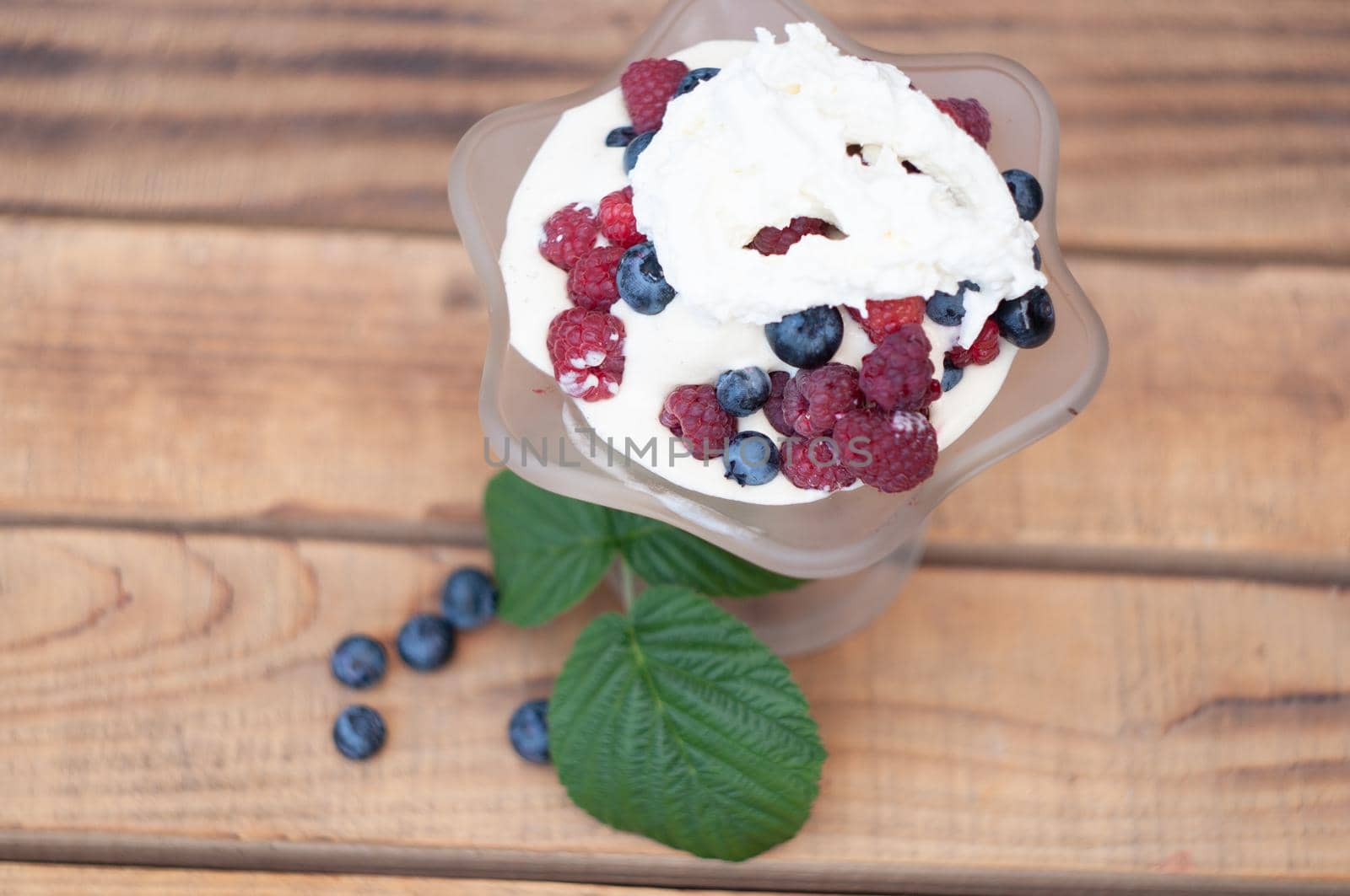 Vanilla ice cream with fresh berries and whipped cream, summer dessert with natural vitamins. High quality photo