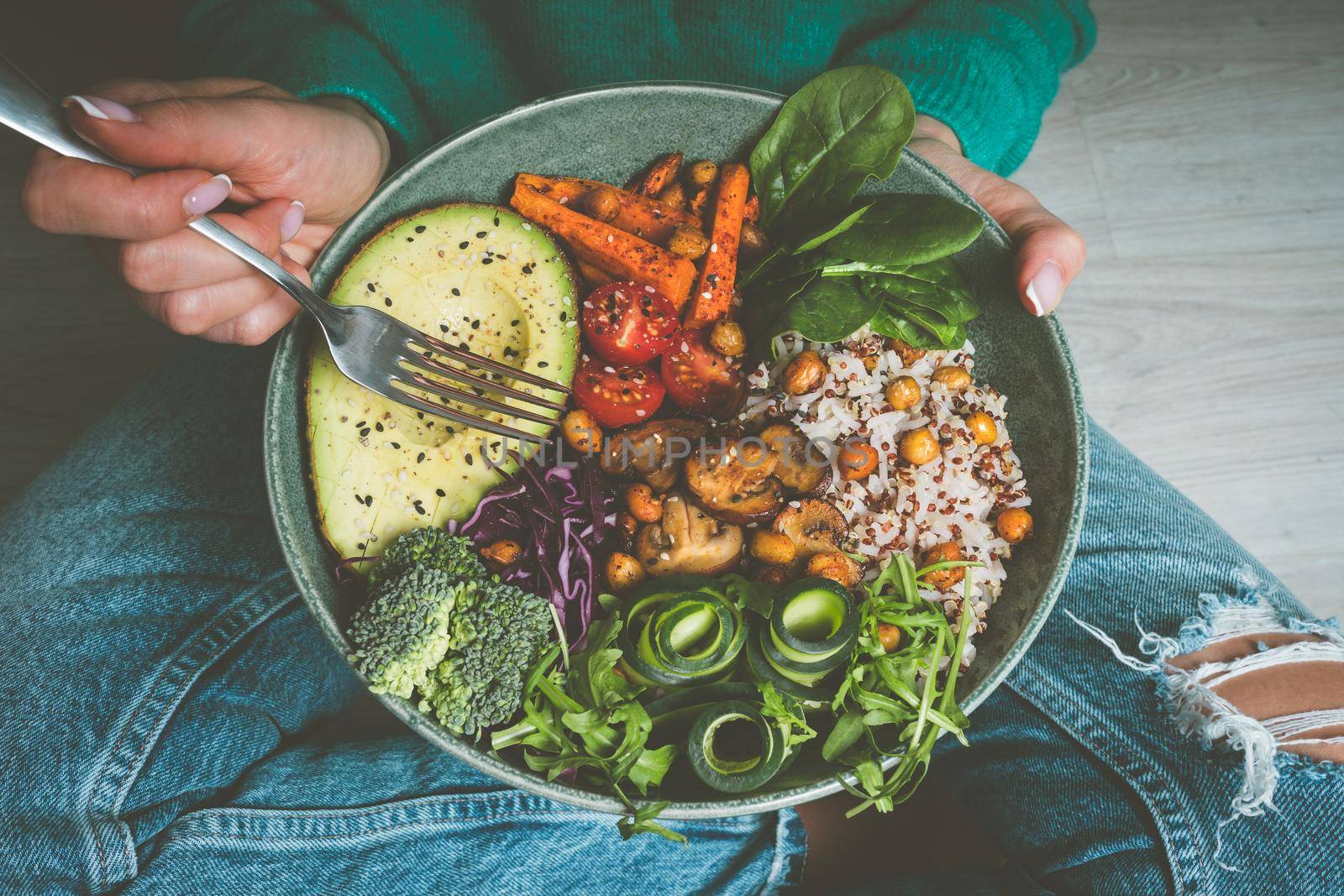 Woman holding plate with vegan or vegetarian food. Healthy diet. Healthy vegetable dinner or lunch. Tasty buddha bowl. Healthy vegan eating. High quality photo