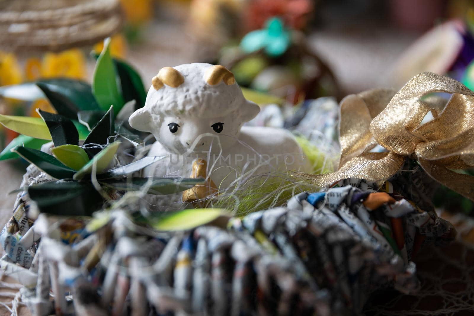 Easter table decoration for home in form of lying lamb in hay. Artistic Polish folk design.