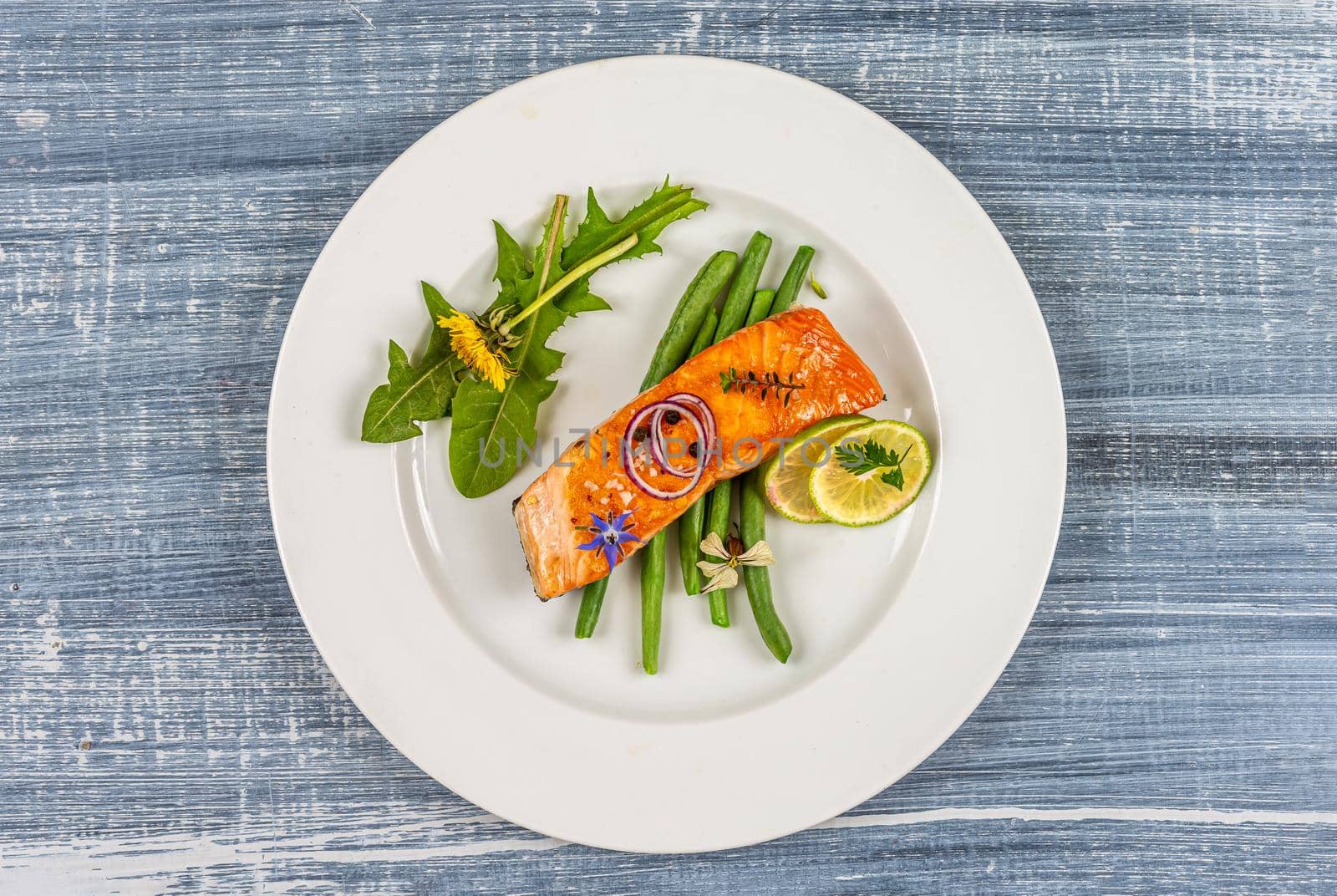 Salmon with green beans and edible flowers, and arugula by JPC-PROD