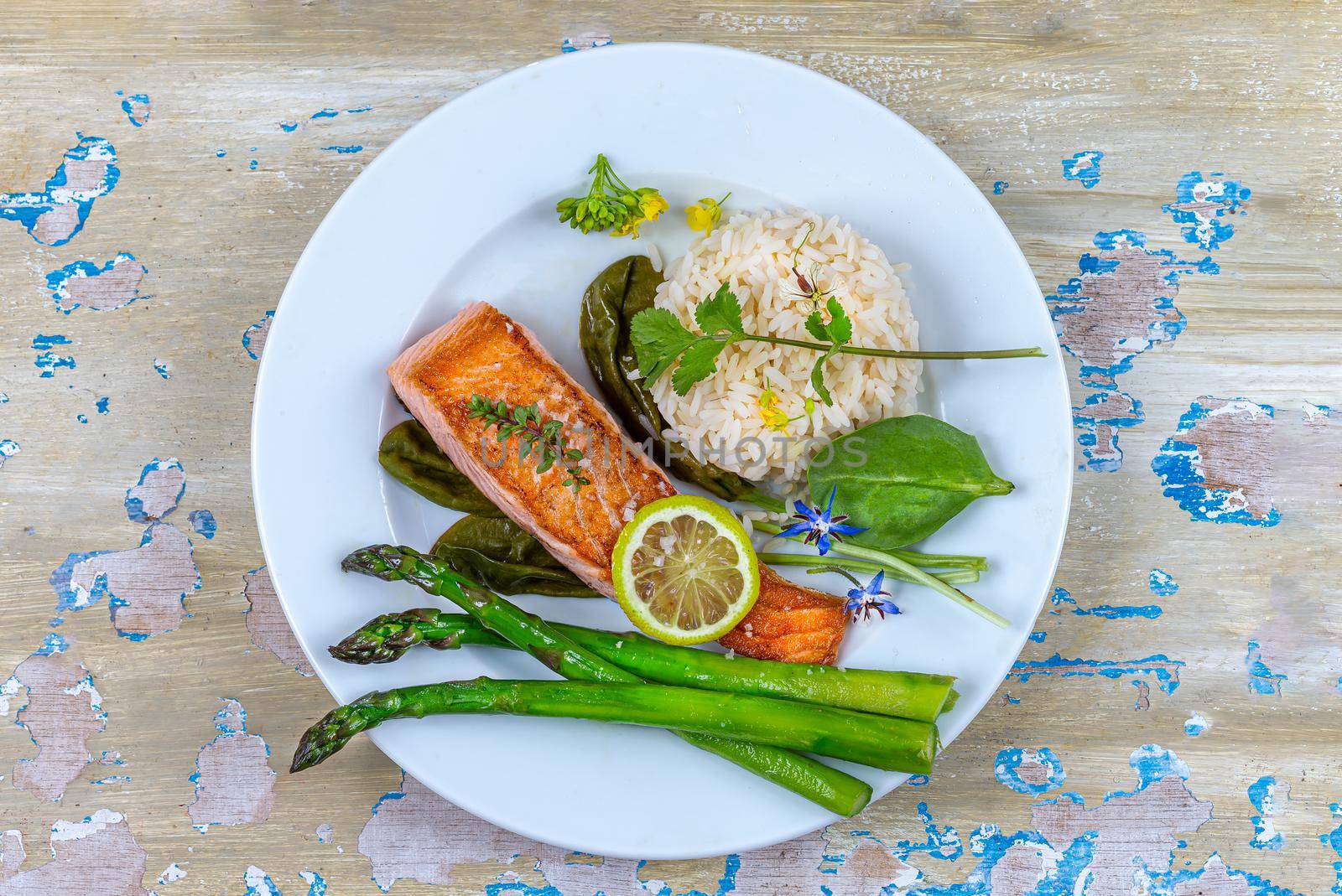 Plate of salmon, asparagus and rice on standby wooden board minimalist photo, by JPC-PROD