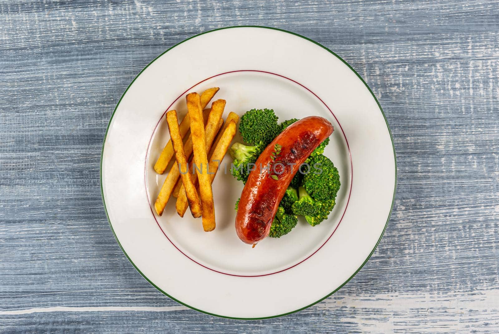 Montb liard sausage accompanied by broccoli and fries