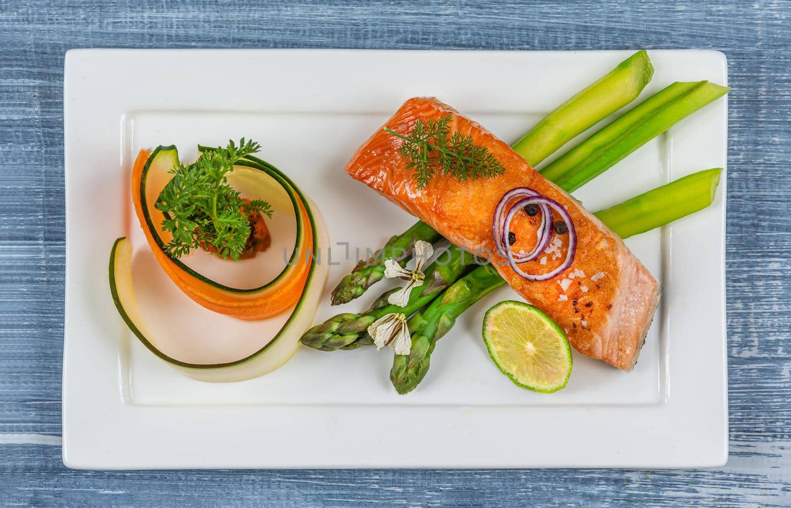 Mininalist presentation of a plate of salmon and vegetables - top view