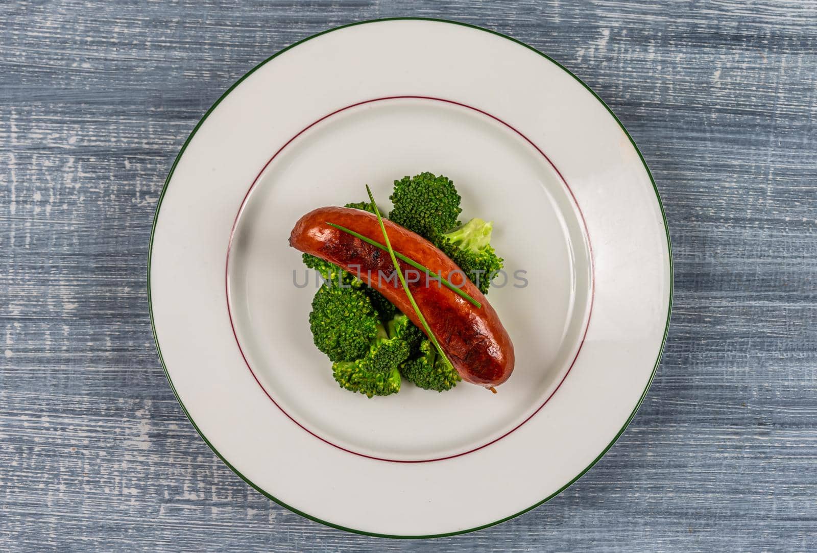 Sausage and broccoli on a plate -Top view