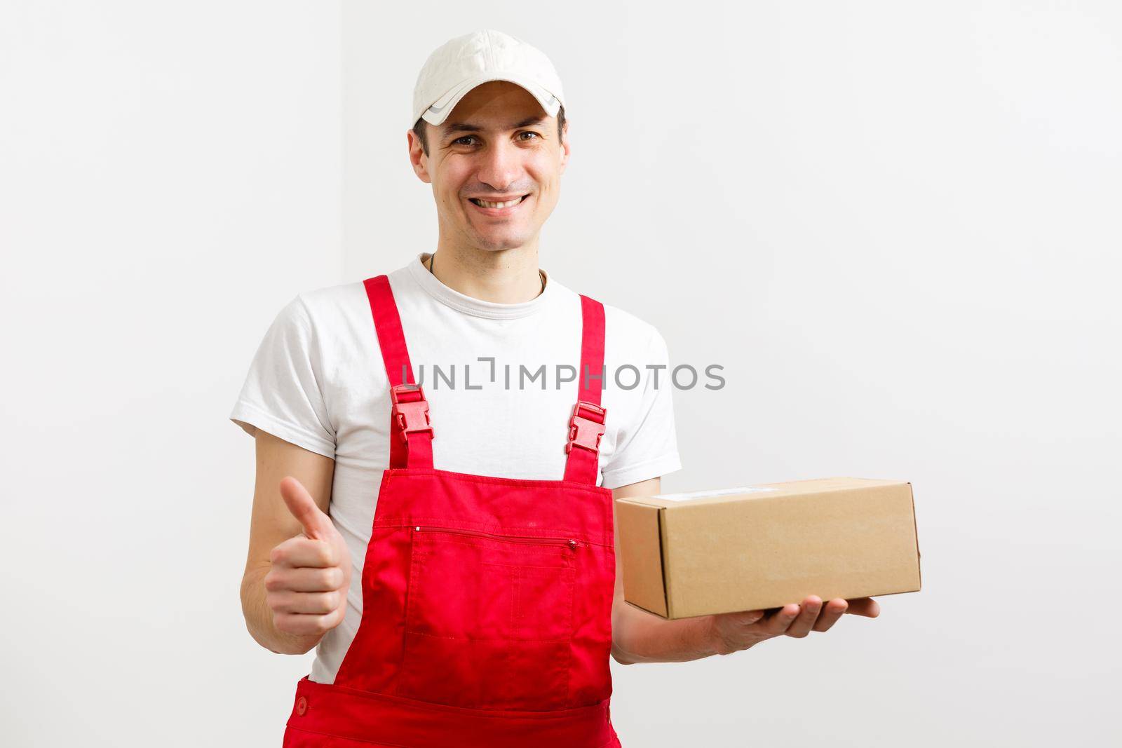 Portrait of happy worker unloading boxes from a delivery van and looking at camera.