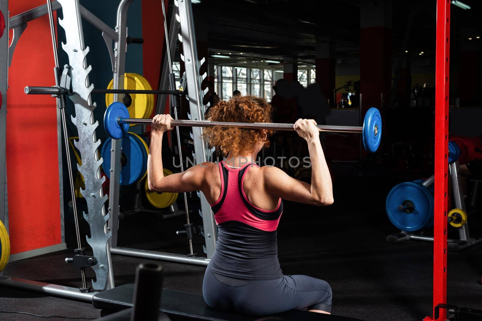 Woman bodybuilder engaged with a barbell in the gym by adam121