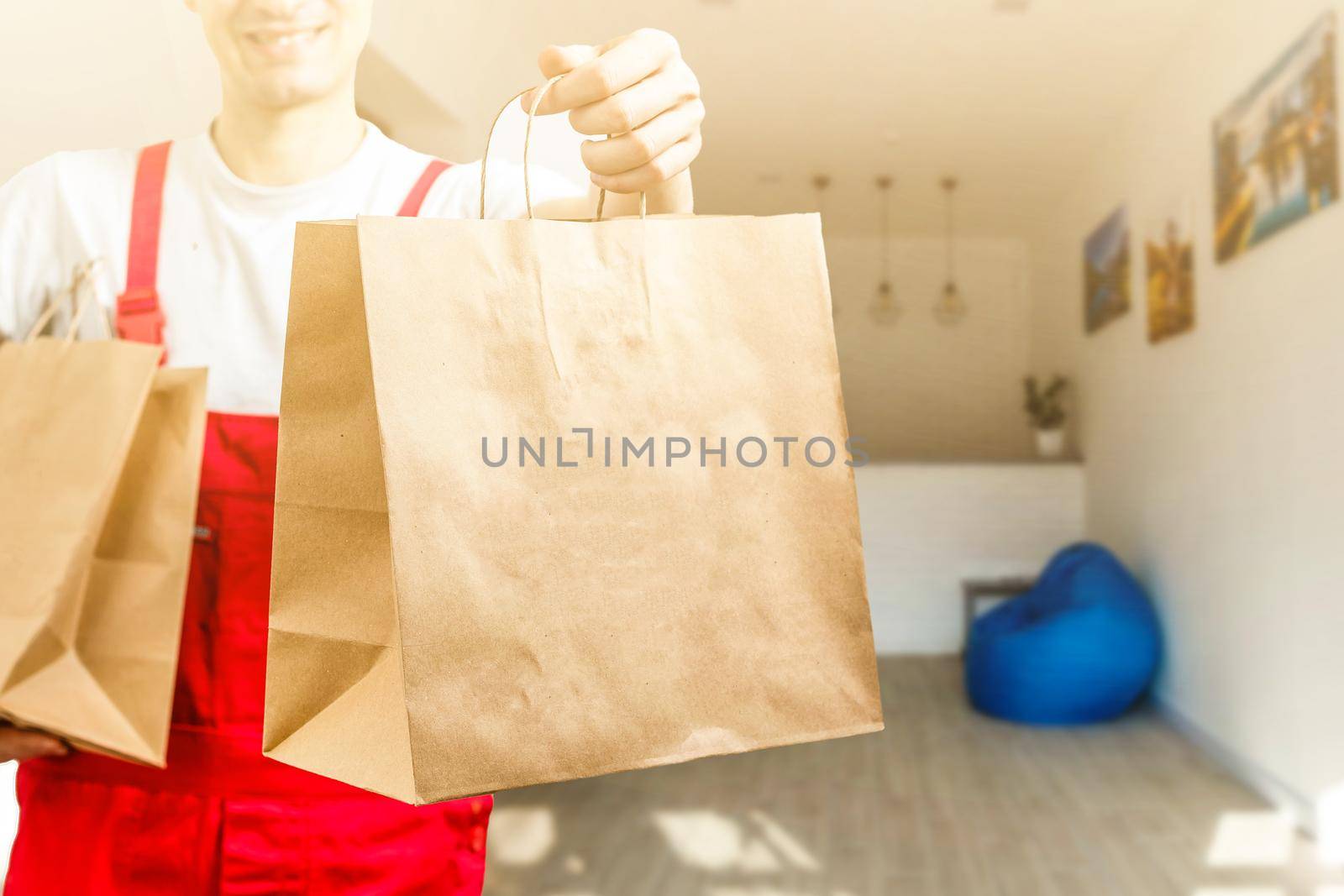 Diverse of paper containers for takeaway food. Delivery man is carrying