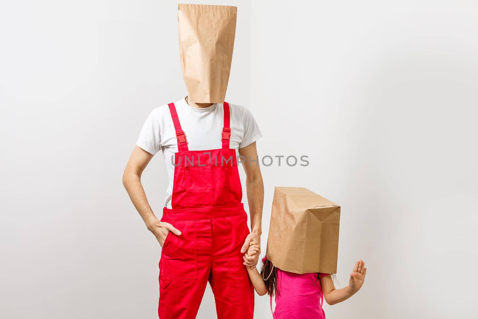 man and little girl with packages on their heads.