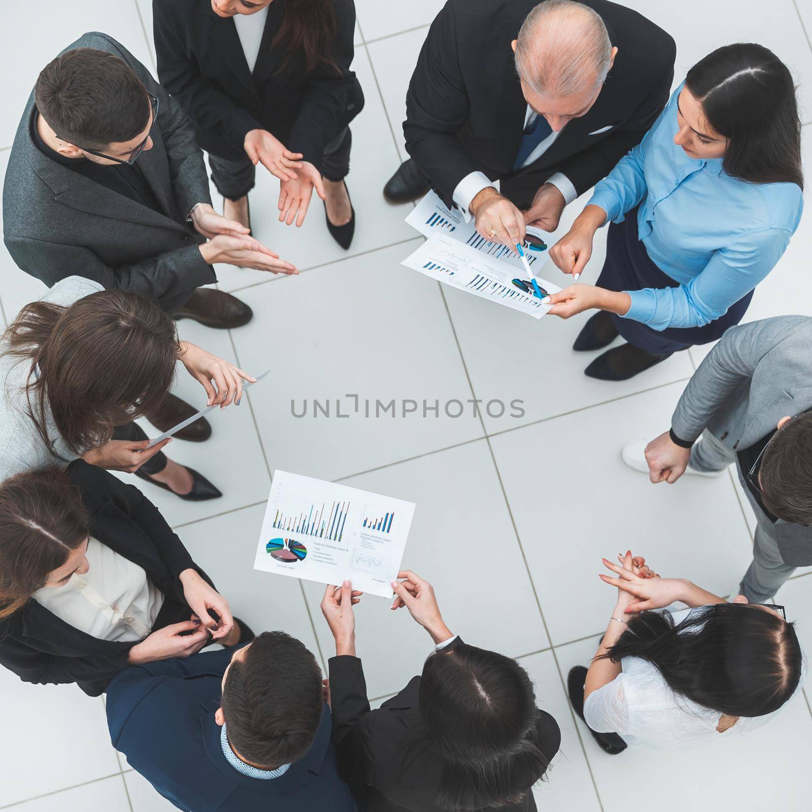 top view. group of corporate employees standing in a circle. by SmartPhotoLab