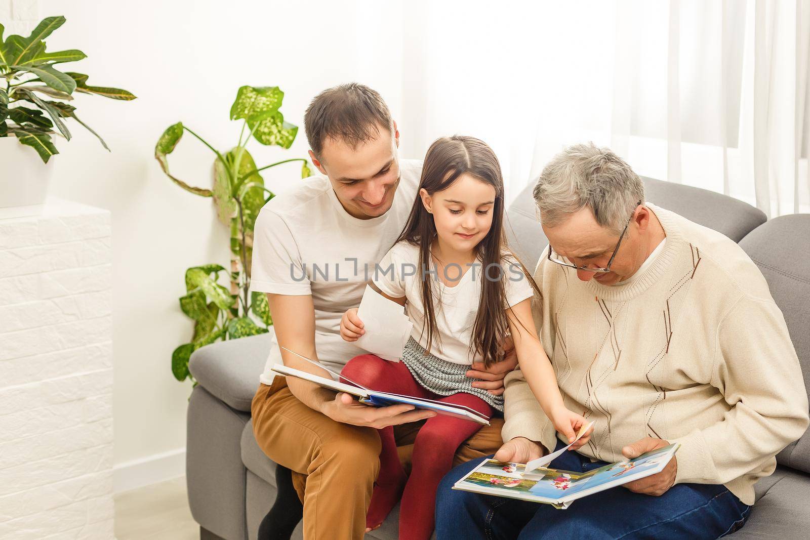 Family looking at a photo album in the living room