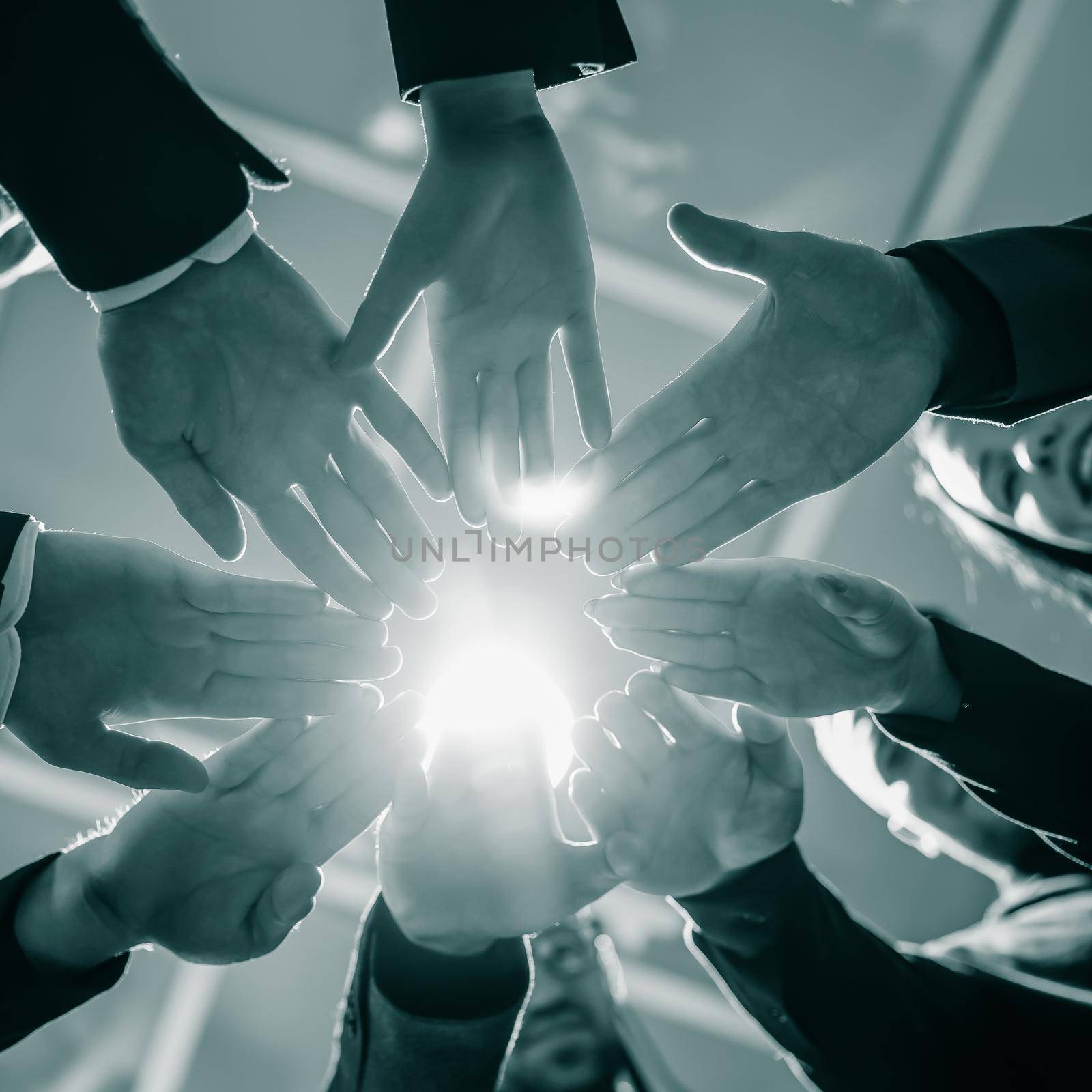 close up. young business people joining their palms in a circle. by SmartPhotoLab