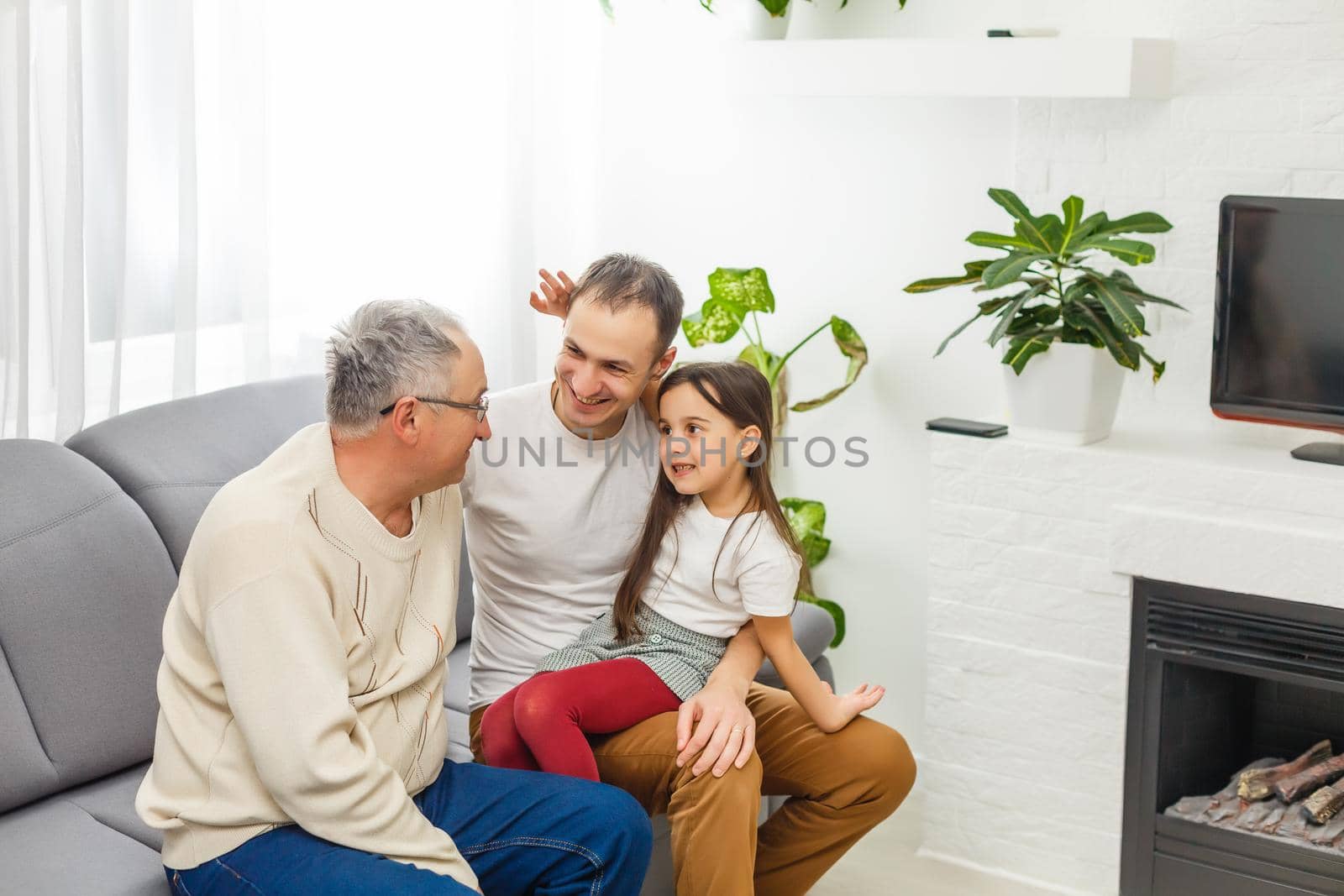 father, son and granddaughter at home