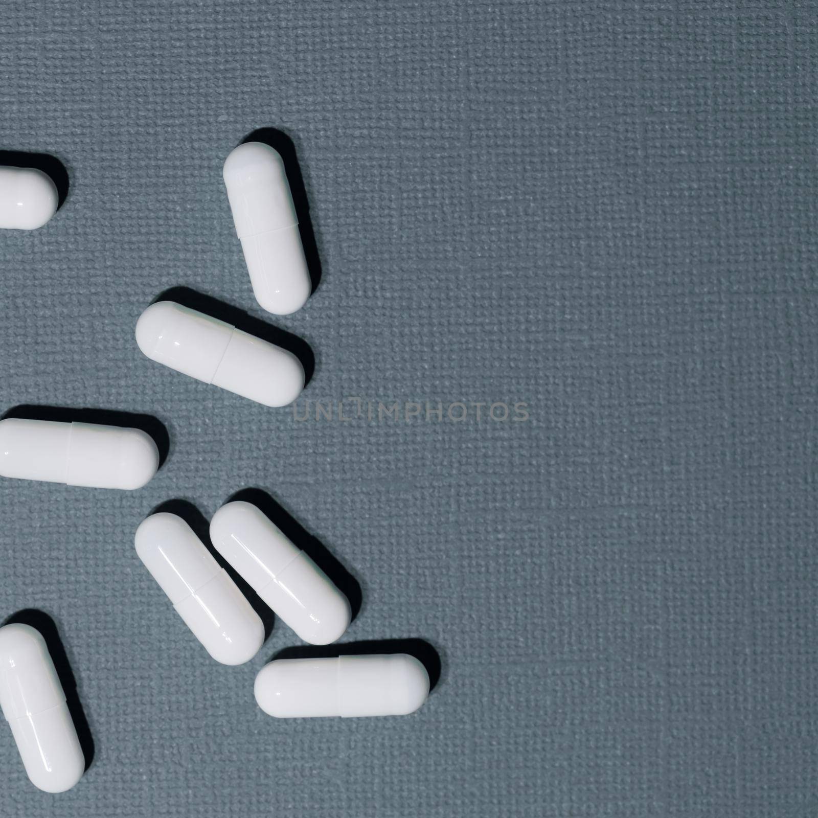 close up. lots of pills on a dark green background. by SmartPhotoLab