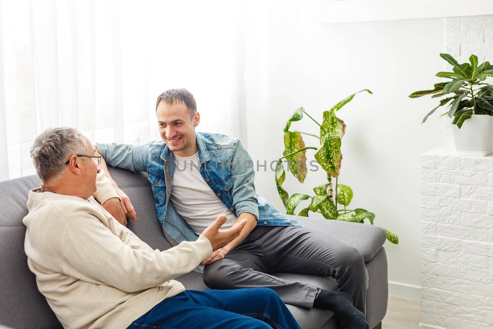 Hipster son with his senior father at home by Andelov13