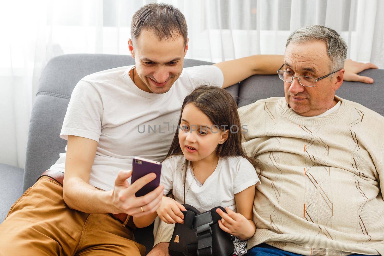 Big happy multigenerational family father, senior grandparents with cute little girl granddaughter at home. Family and love concept by Andelov13