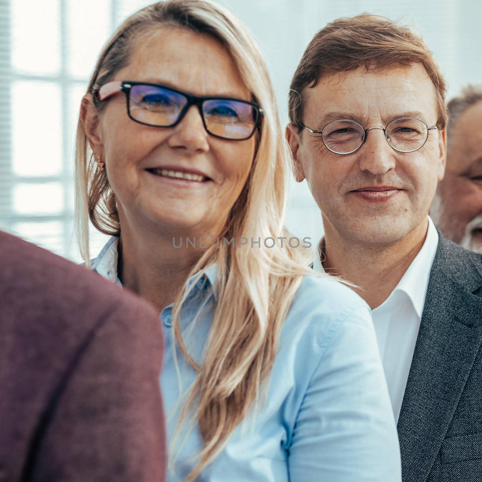 close up. smiling business people standing in one after another. by SmartPhotoLab
