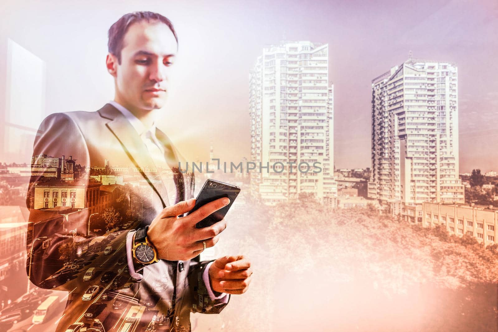The double exposure image of the business man using a smartphone during sunrise overlay with cityscape image. The concept of modern life, business, city life and internet of things
