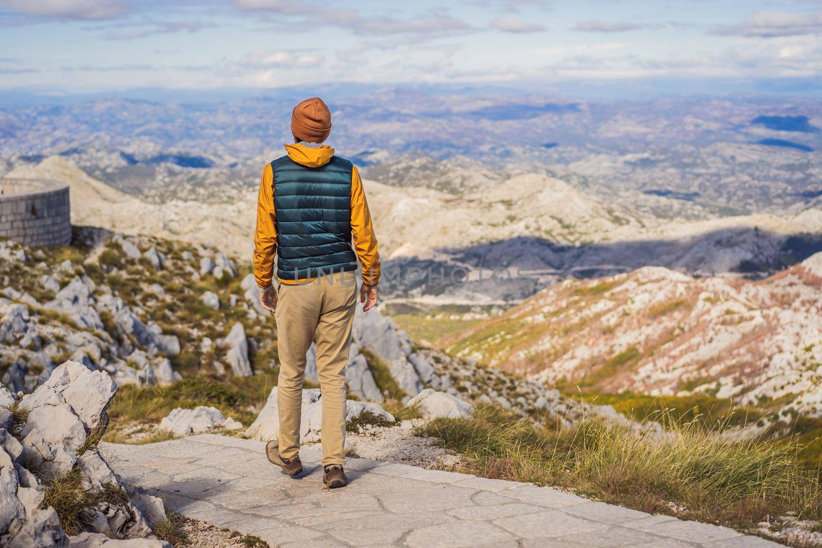 Man traveller in mountain landscape at national park Lovcen, Montenegro. Travel to Montenegro concept.