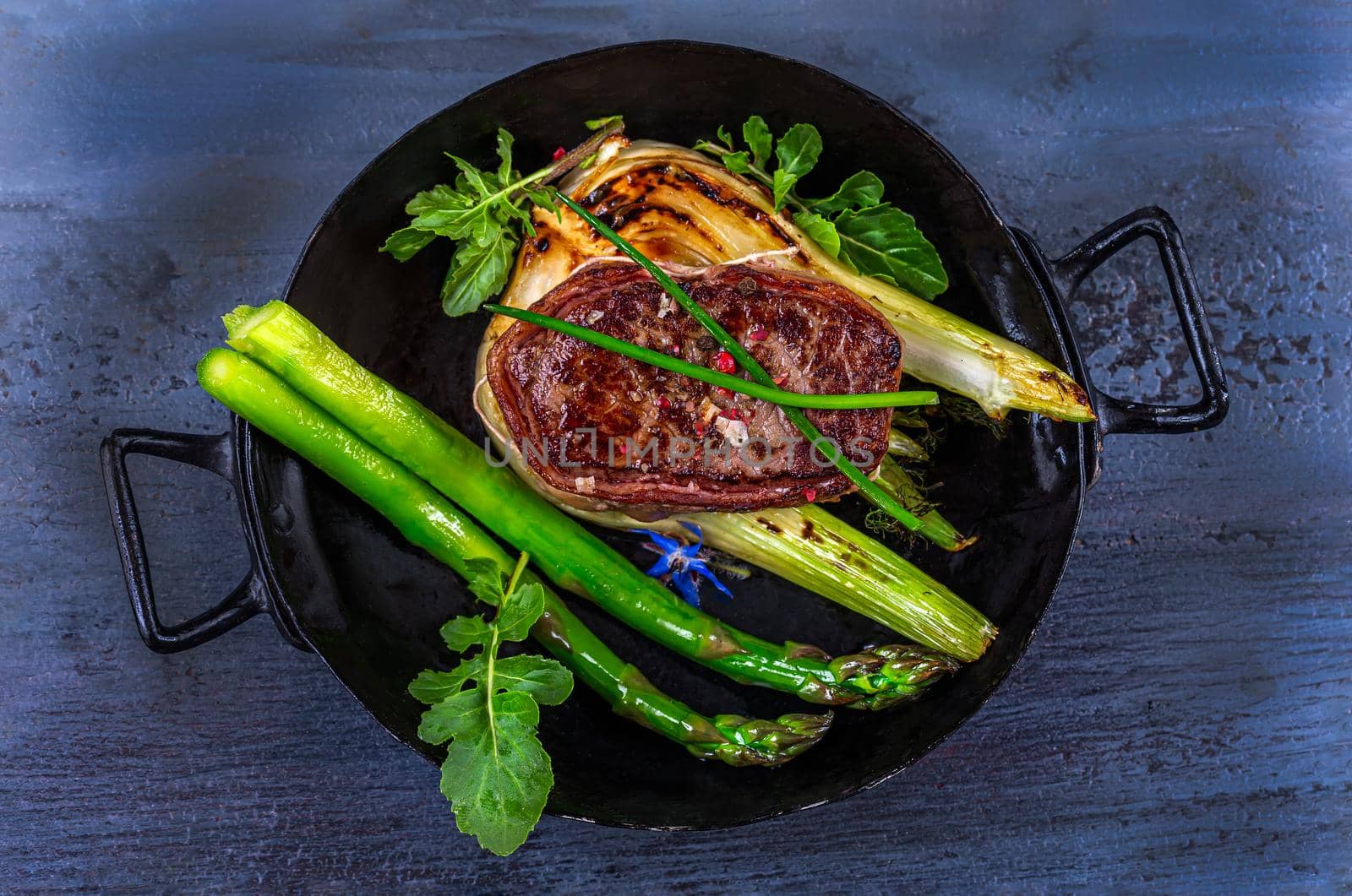 Tournedos and vegetables grilled in an old black dish. by JPC-PROD