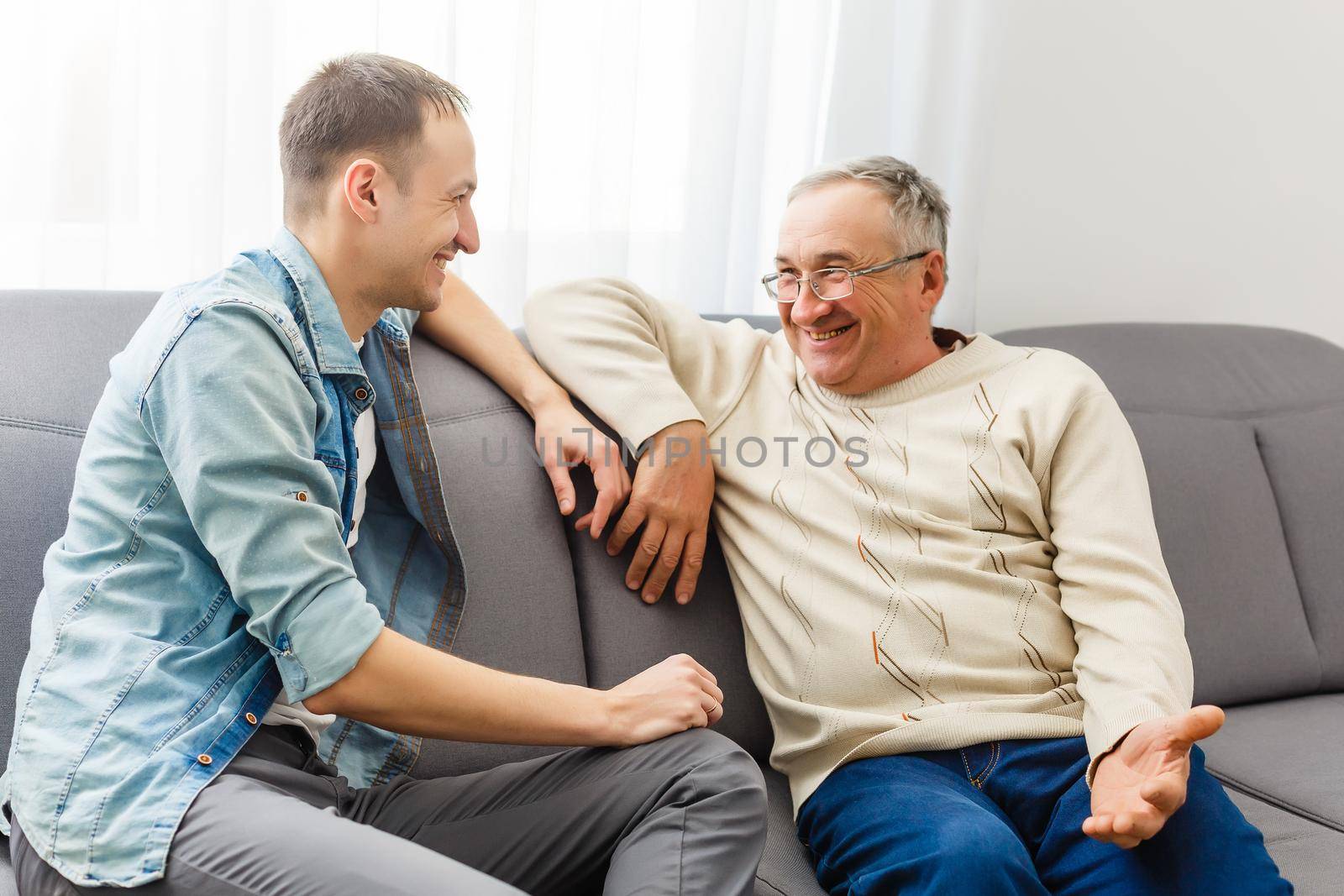 Two men in living room talking