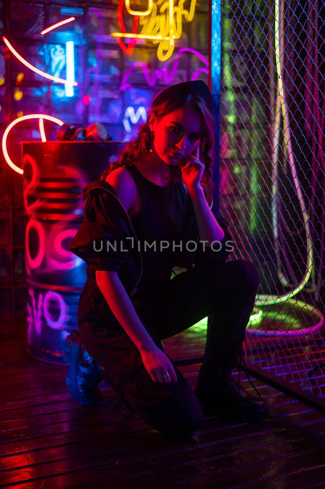 Caucasian woman posing in neon studio