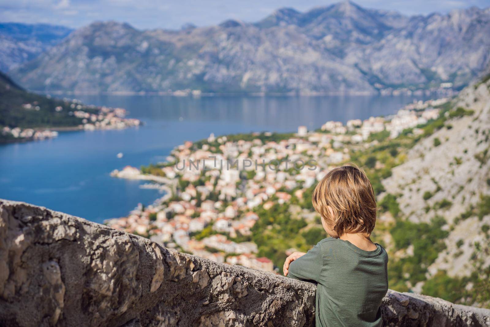 Boy tourist enjoying Colorful street in Old town of Kotor on a sunny day, Montenegro. Travel to Montenegro concept by galitskaya