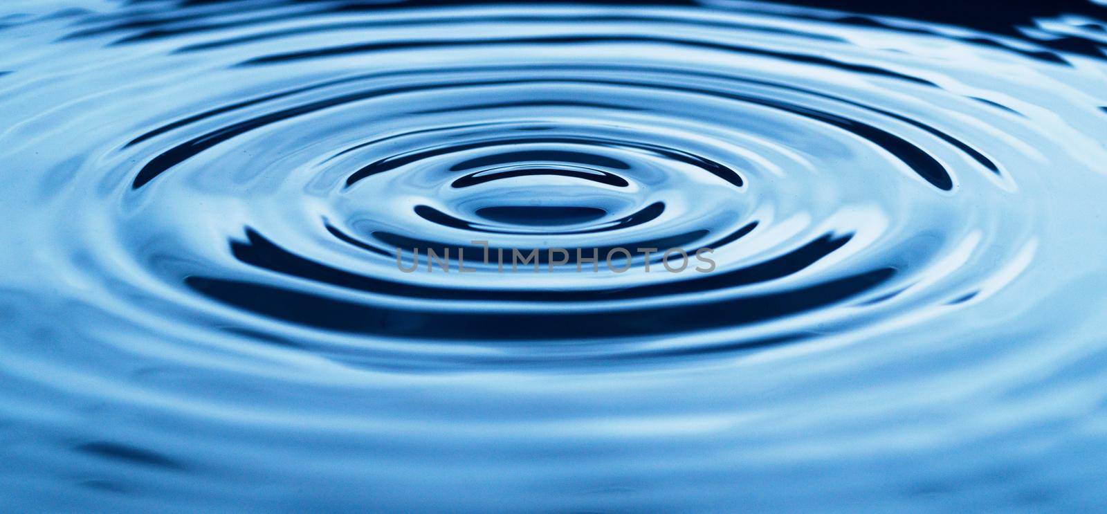 Abstract studio shot of ripples in a puddle of water.