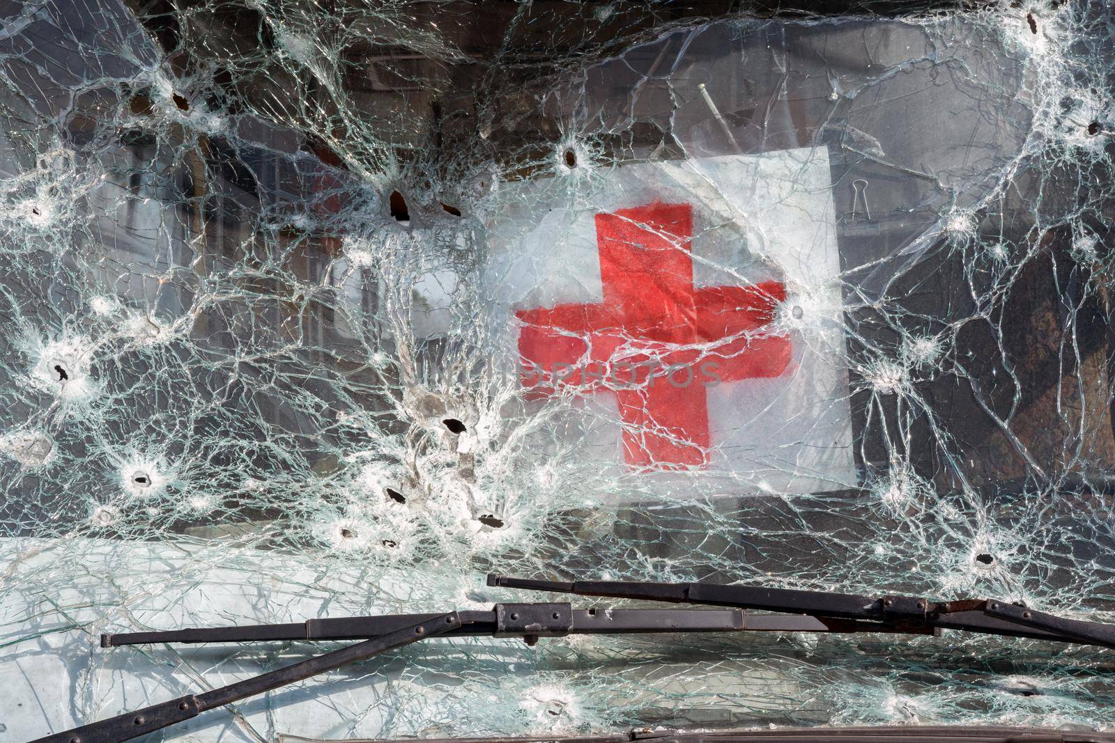 Bus evacuating civilian shooting bullet glass hole shot bullet windshield broken icon red cross sign humanitarian logo. 2022 War Russia invasion Ukraine war crimes. Mark bullet car destroyed bus crash by synel