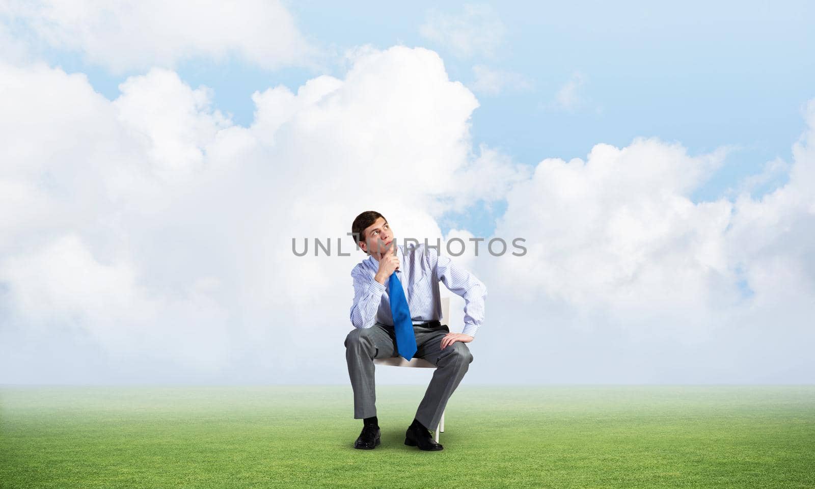 Young businessman sitting on an office chair by adam121
