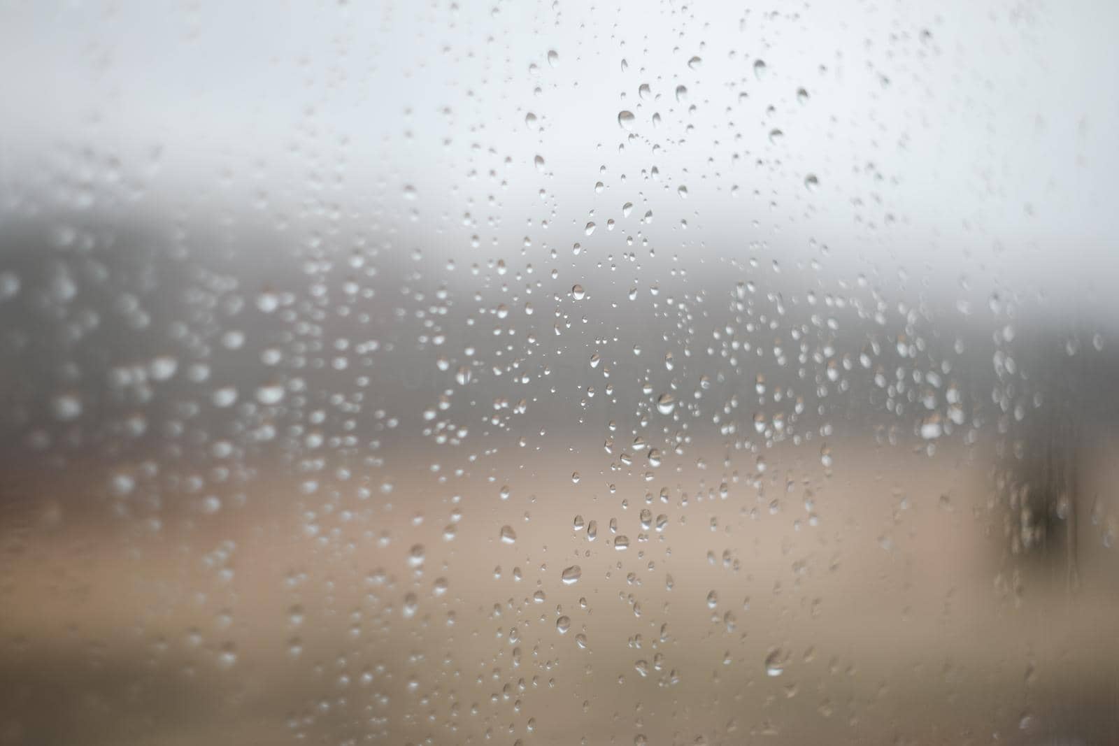 Natural pattern of rain drops on window glass surface