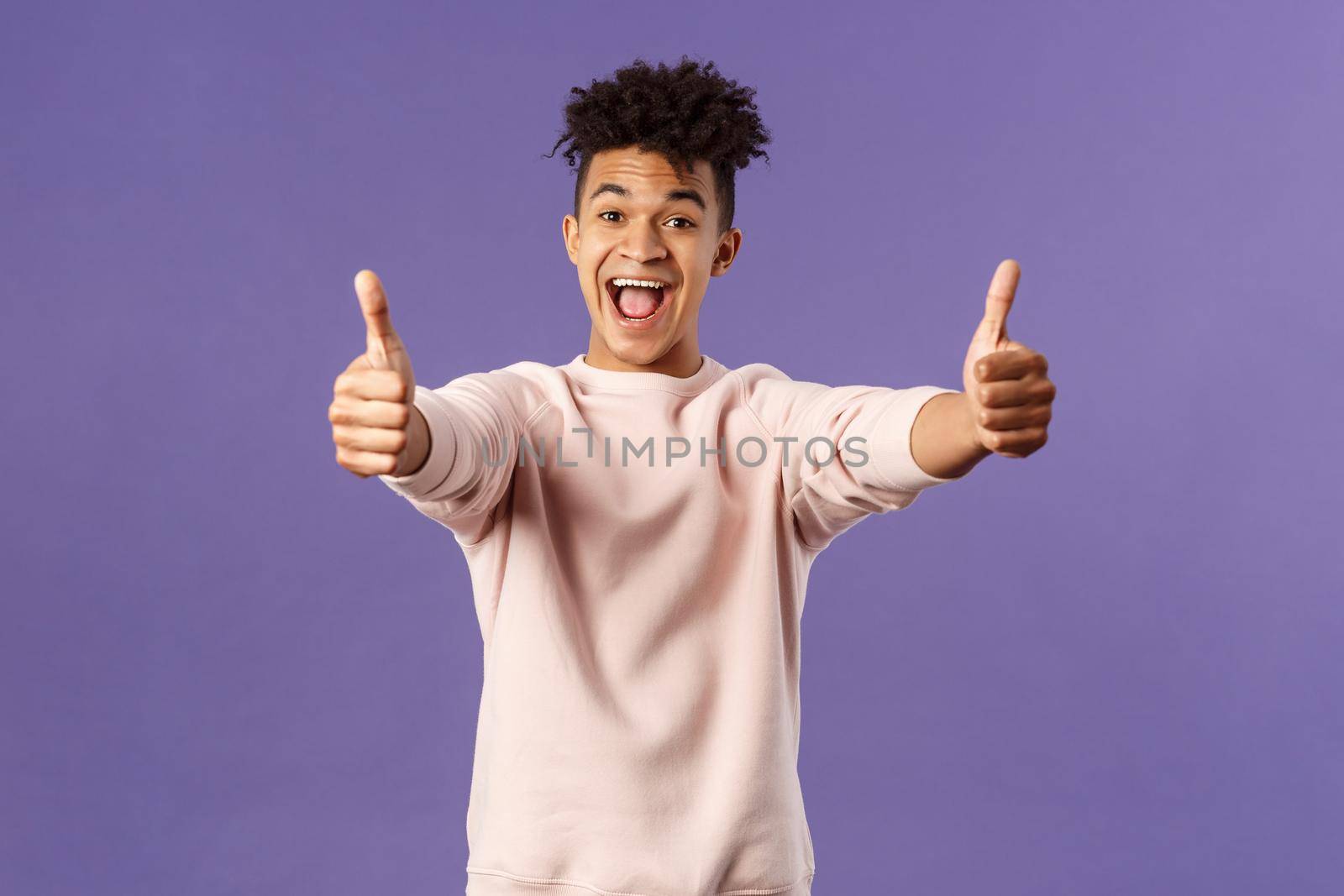 Portrait of satisfied young happy man think event was super cool, recommend use company service, assure in best quality, like and approve awesome product, standing purple background.