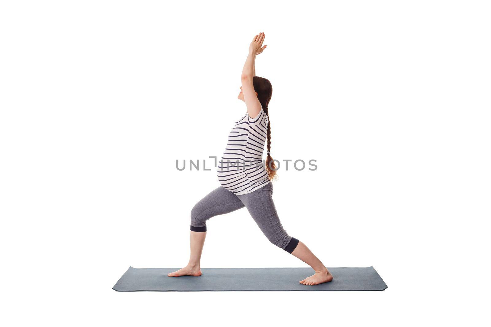 Pregnant woman doing yoga asana Virabhadrasana 1 by dimol