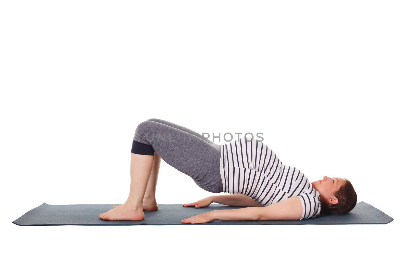 Pregnant woman doing yoga asana Purvottanasana by dimol