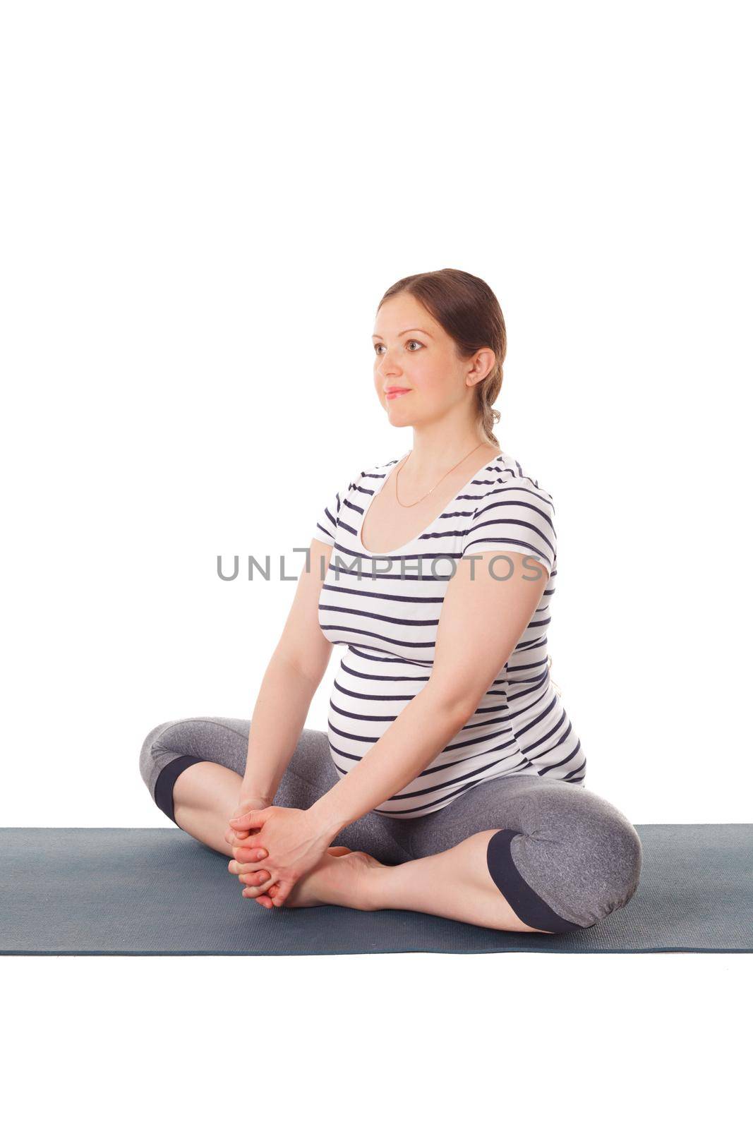 Pregnant woman doing yoga asana Baddha Konasana by dimol