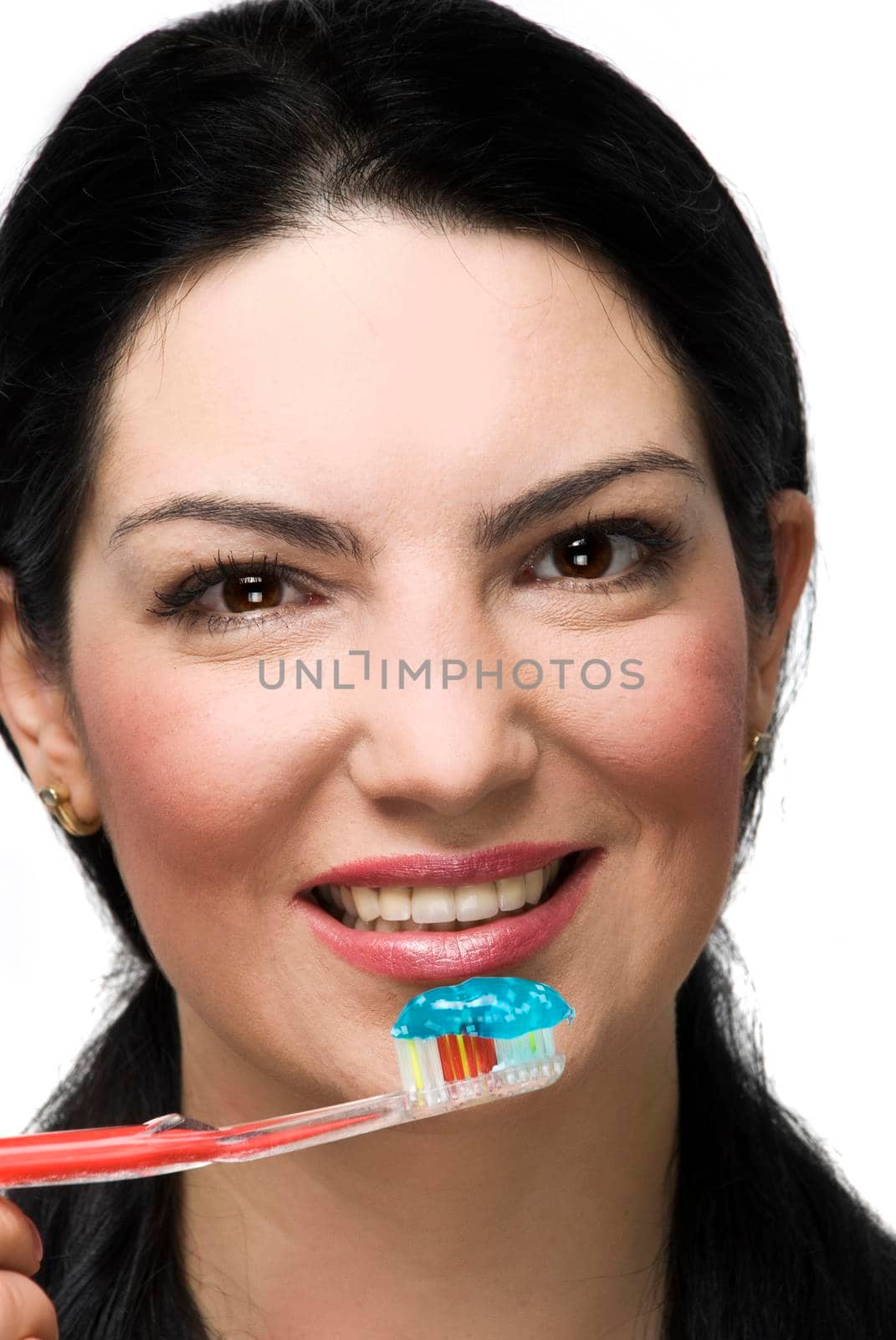 Close up of beautiful brunette woman ready to brush her teeth and smiling for you