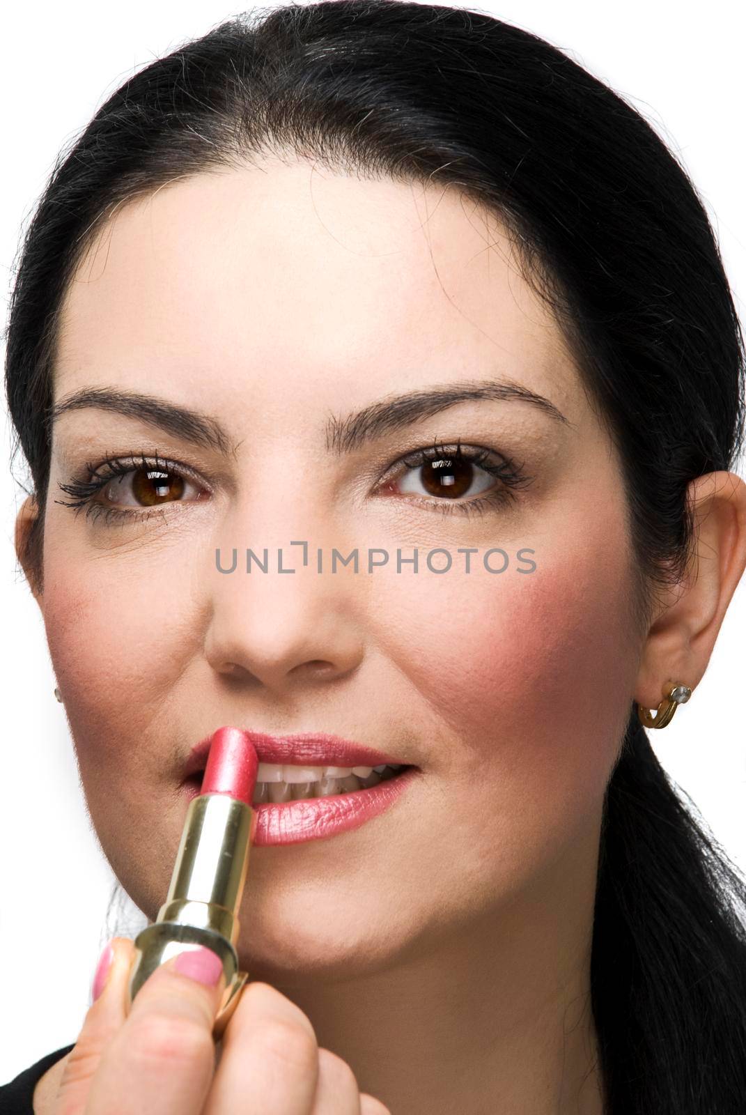 Woman applying pink lipstick by justmeyo
