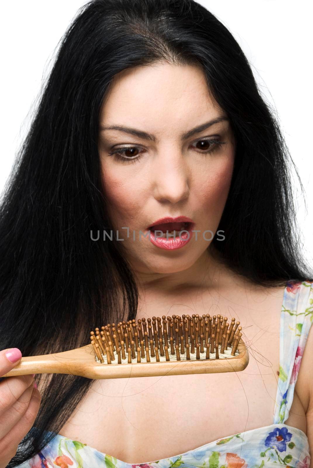 Shocked woman discover how much hairr loss on hairbrush,focus on hairbrush isolated on white background