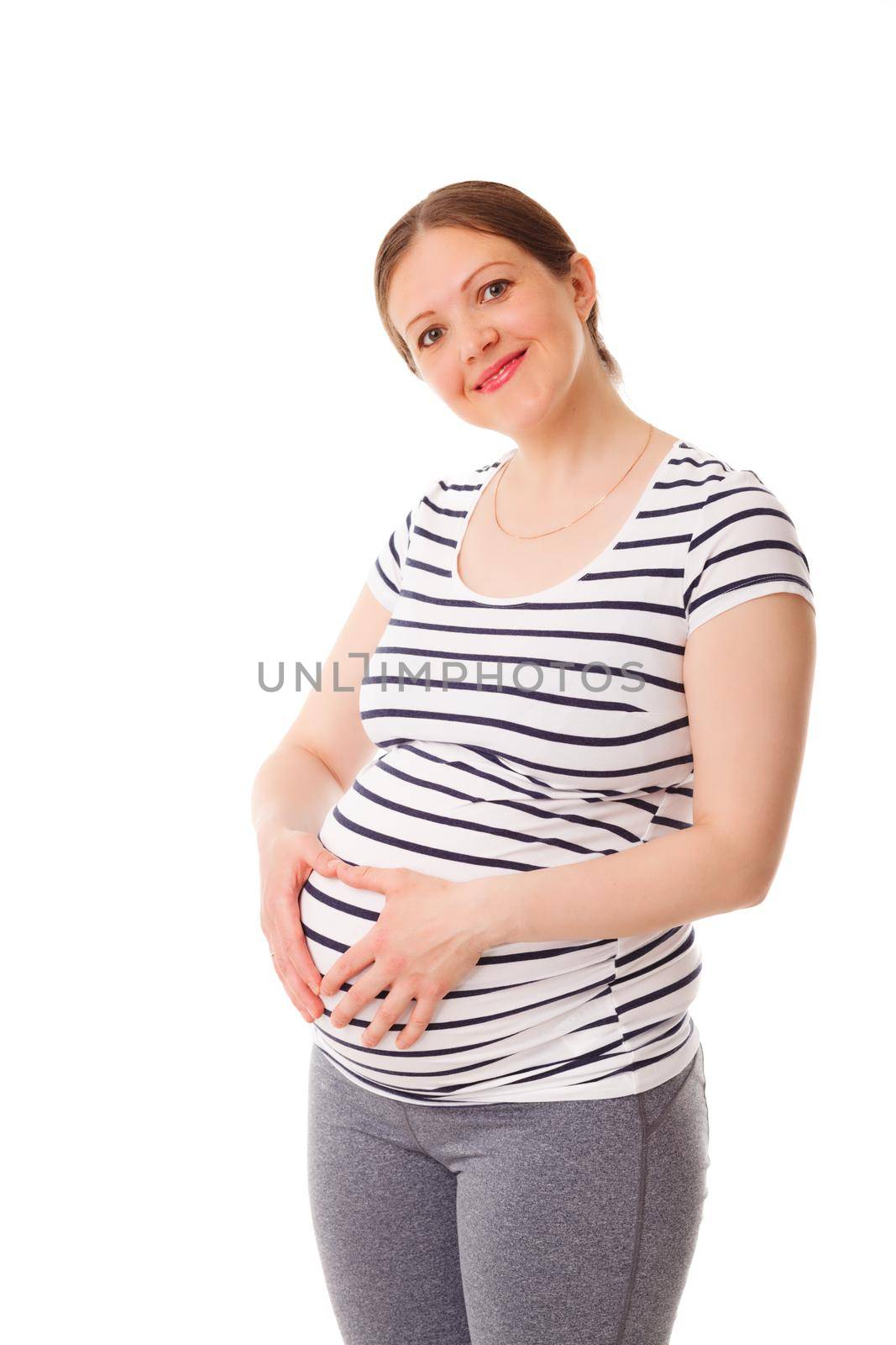 Pregnant smiling woman standing embracing her belly isolated on white background