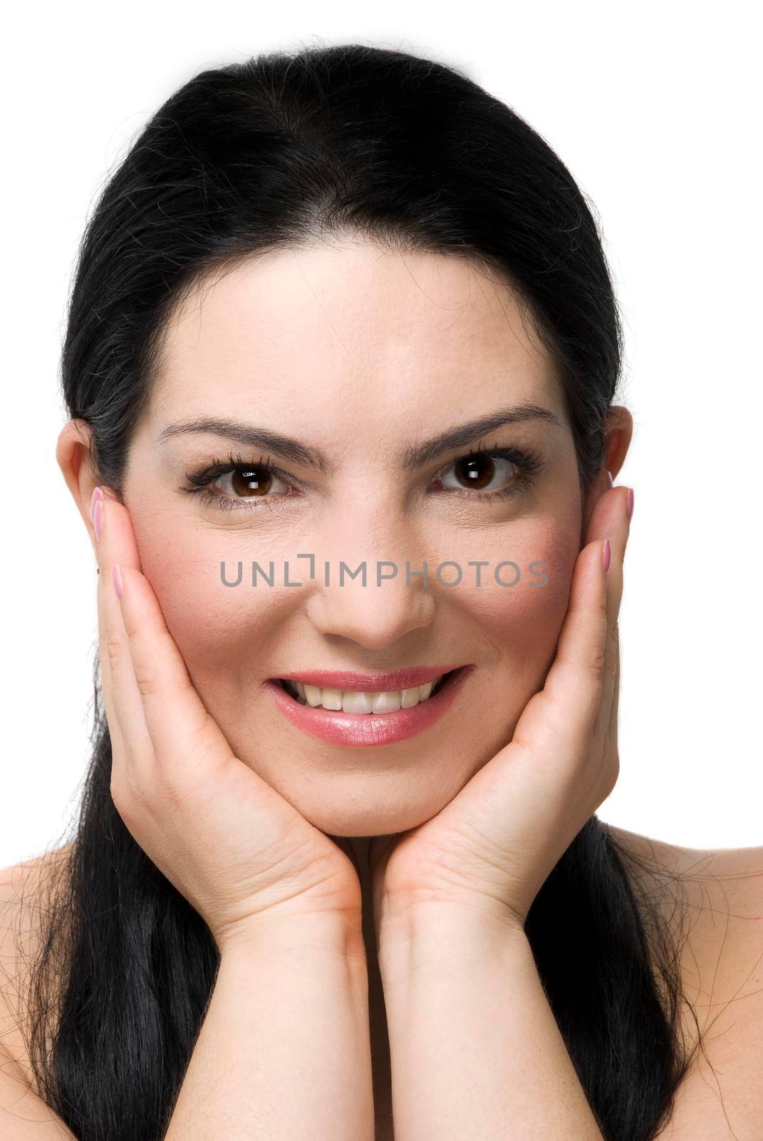 Portrait of lovely woman smiling and holding her face in hands isolated on white background