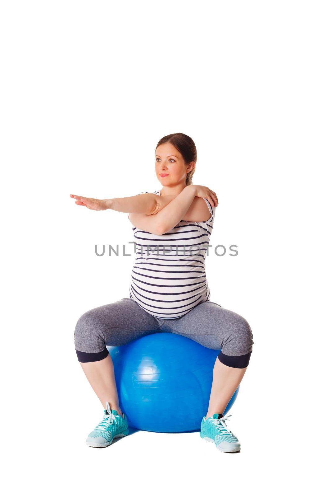 Pregnancy exercise concept - pregnant woman doing stretching exercises with exercise ball isolated on white background