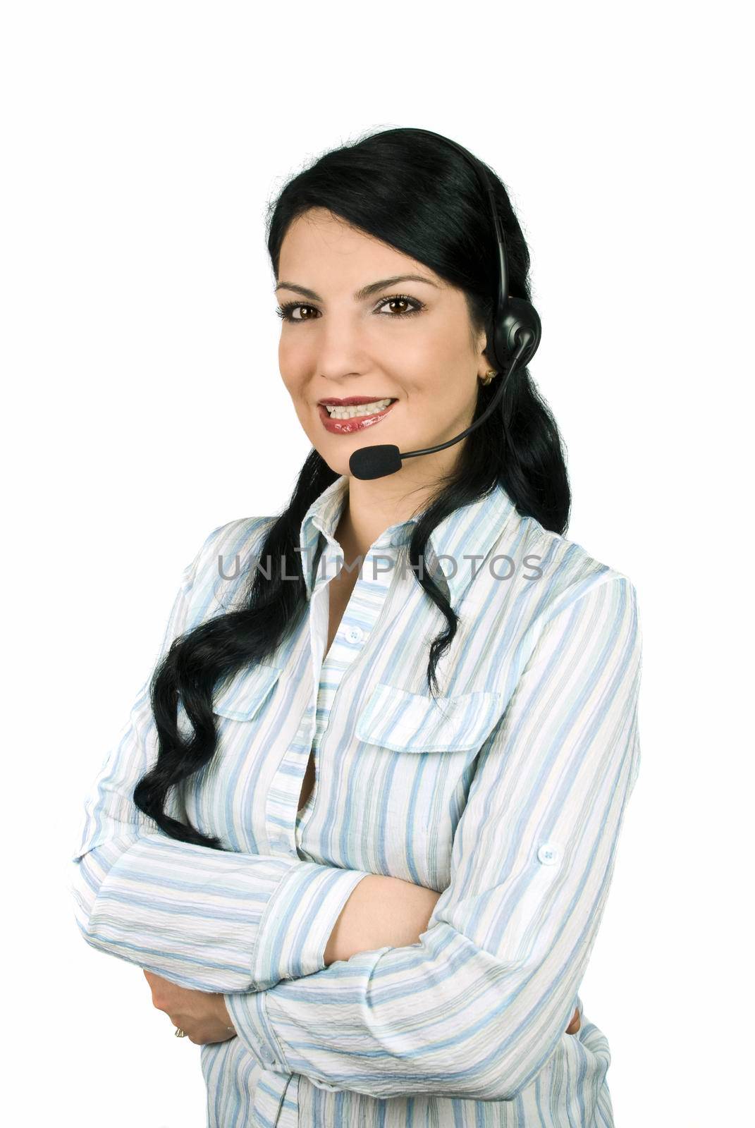 Beautiful woman operator working in a Call Center standing with hands crossed and smiling